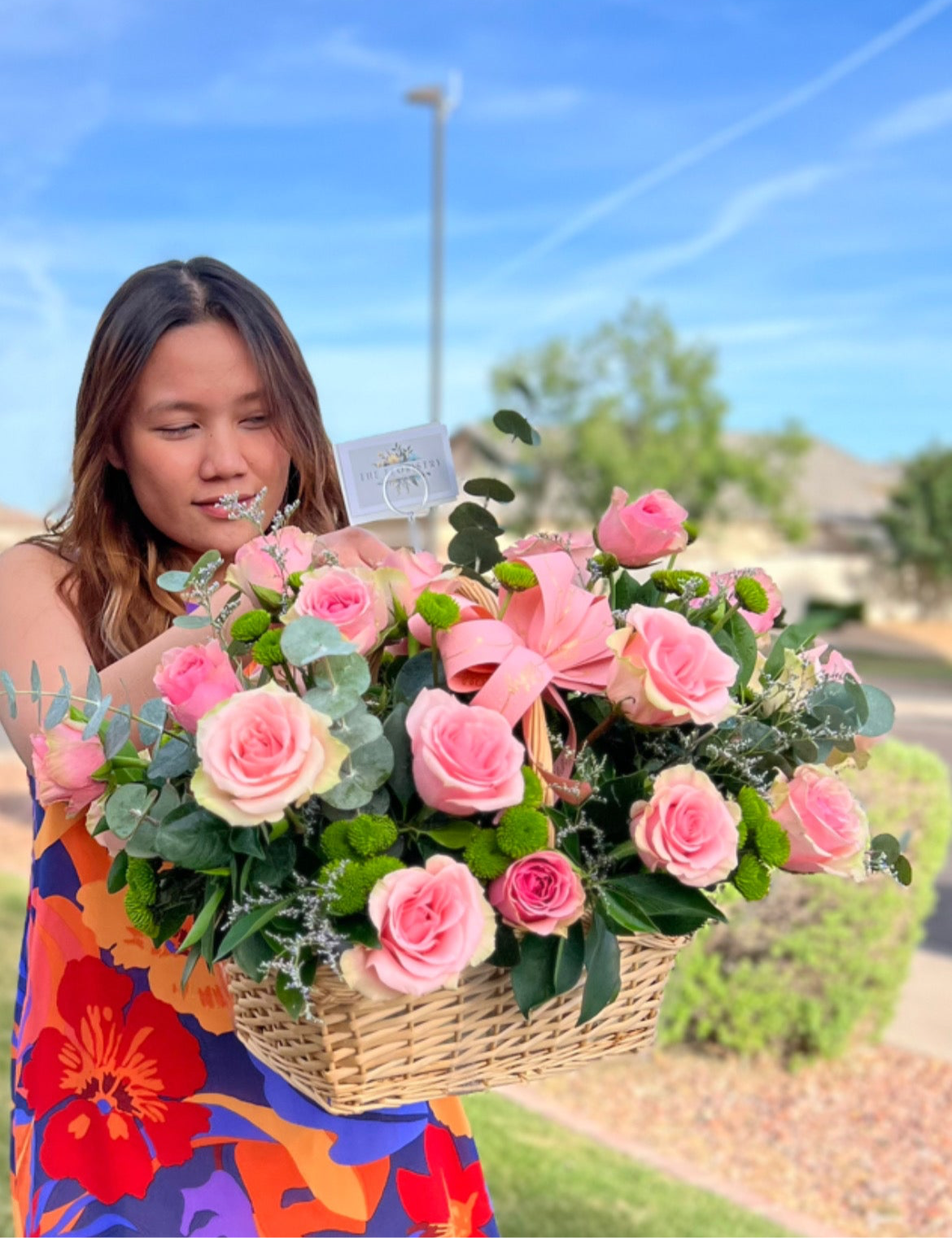 Romantic red rose basket arrangement with eucalyptus, daises