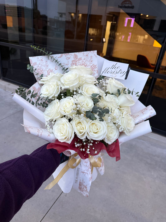 Elegant white roses wrapping bouquet featuring fresh premium blooms arranged in a clean and timeless style for flower delivery in Gilbert.