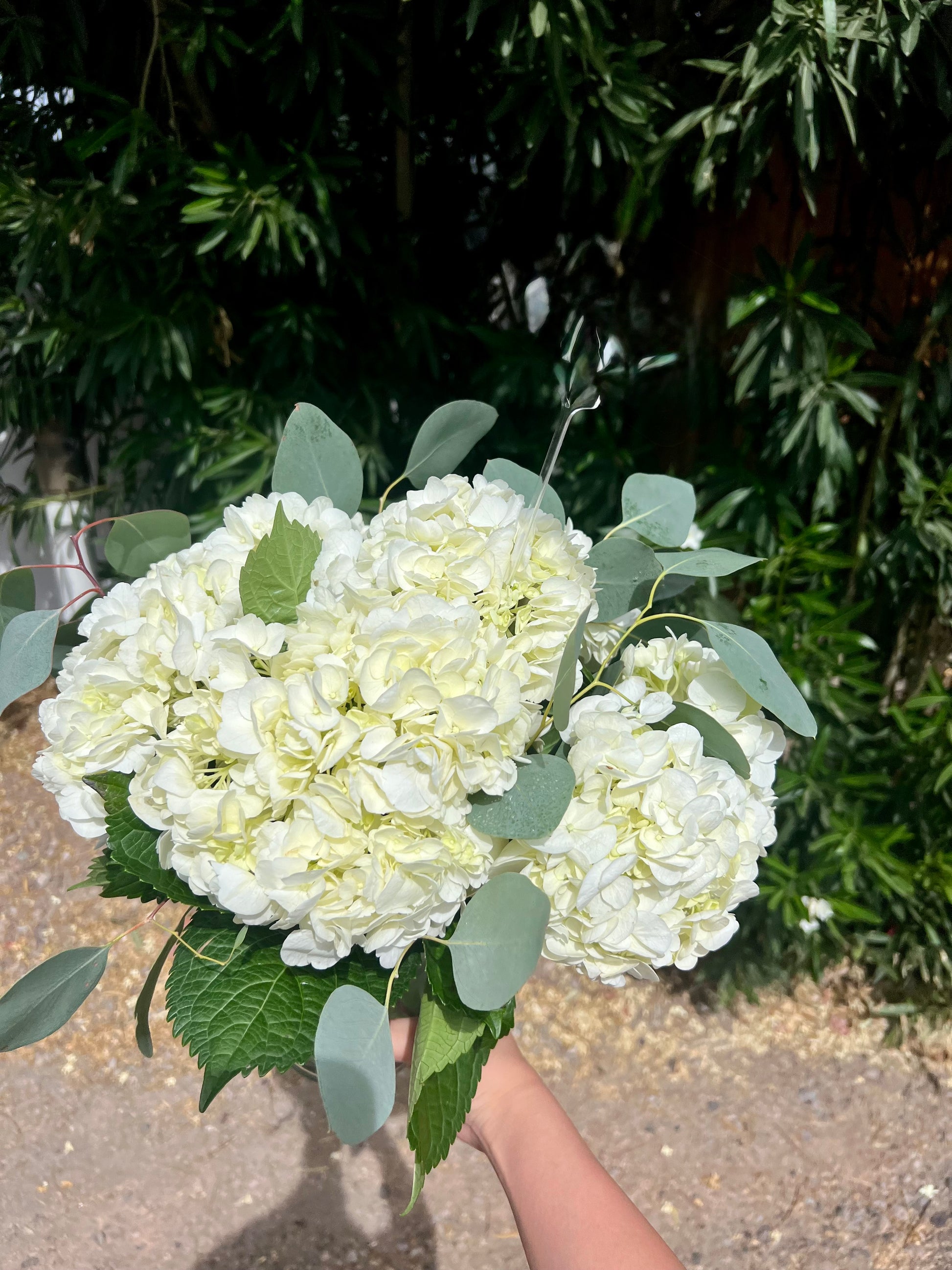 Elegant white hydrangea bouquet centerpiece.
