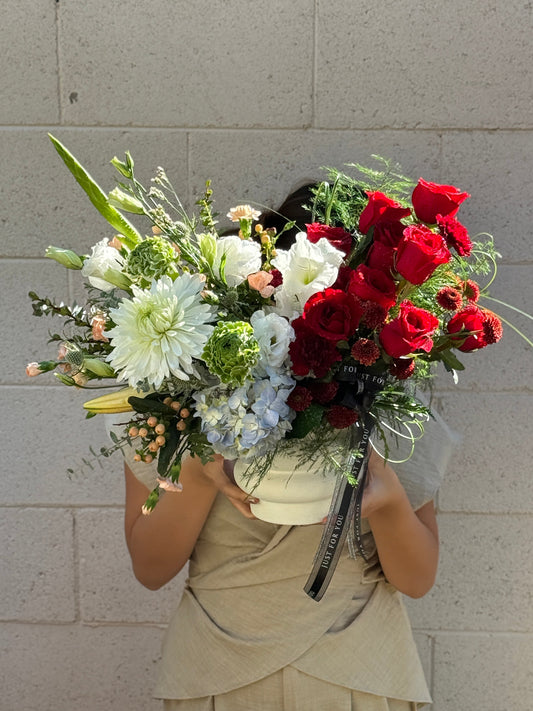 A unique florist designed centerpiece with contrasting colors that create a striking visual. Ideal for Valentine’s Day, anniversaries, birthdays, and congratulations.