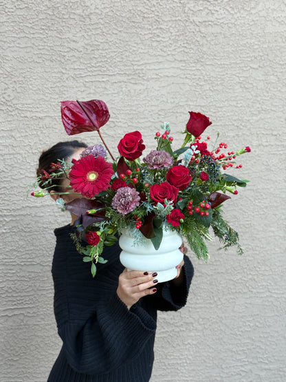 Moody red and wine tone floral centerpiece with elegant white flowers for table decor.