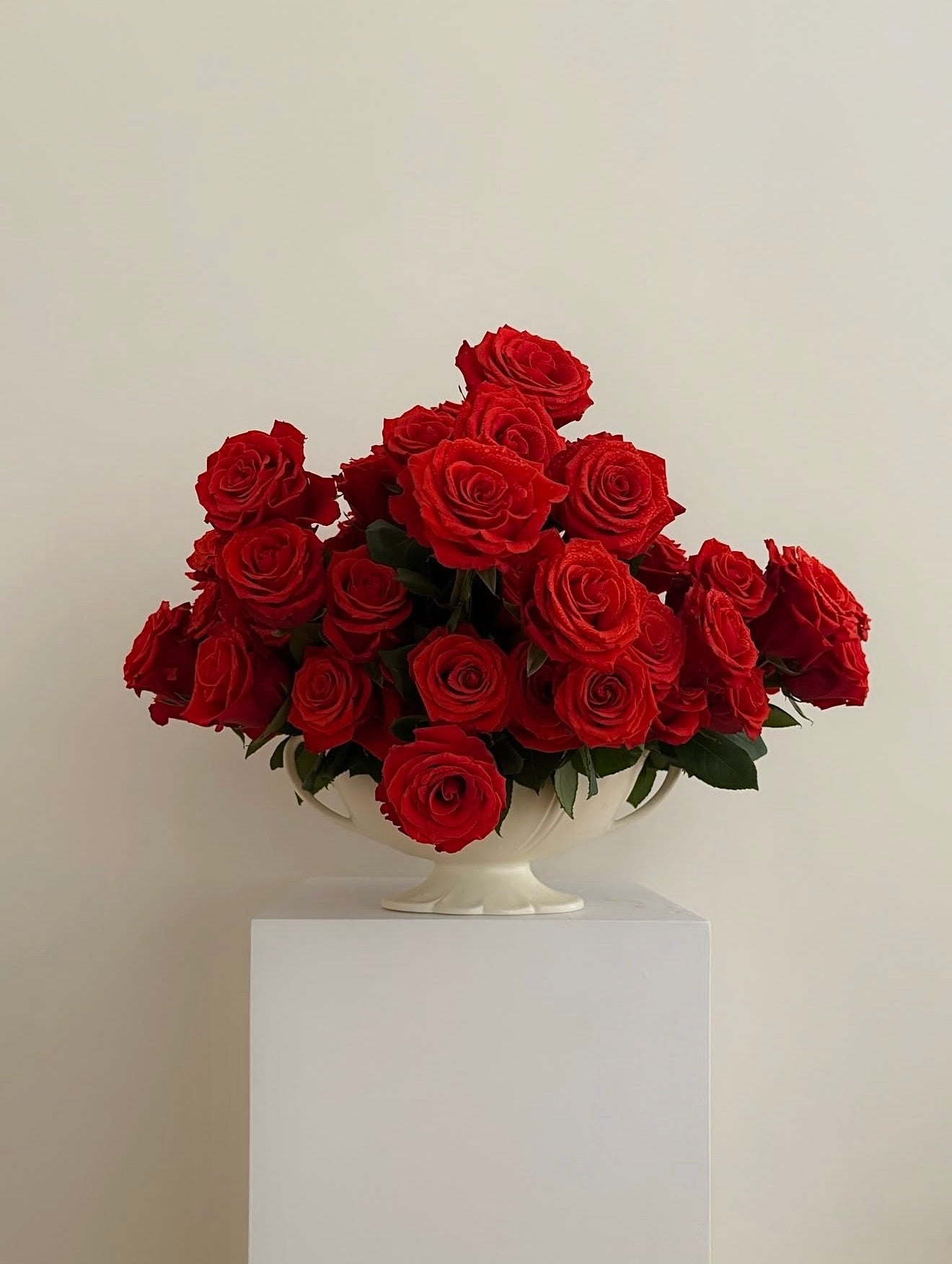 Close-up of premium red roses arranged in a free-form, expressive luxury centerpiece