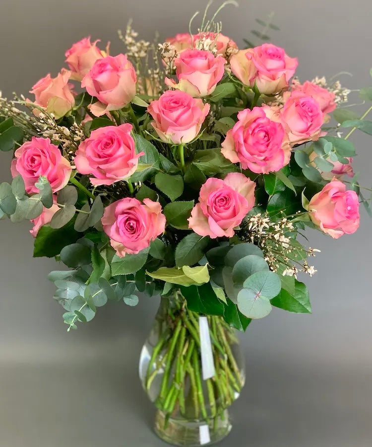 Elegant pink roses bouquet arranged in a vase, handcrafted by florists for same day delivery.
