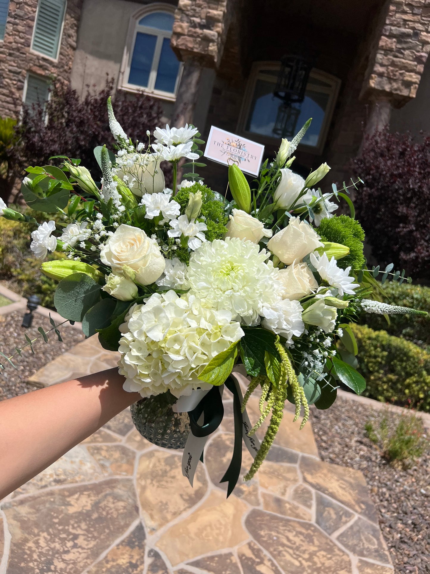 Bouquet of white and green flowers held for birthday, anniversary, congratulation. Available for delivery in Phoenix area, Gilbert, Mesa, Chandler, Tempe, Queen Creek