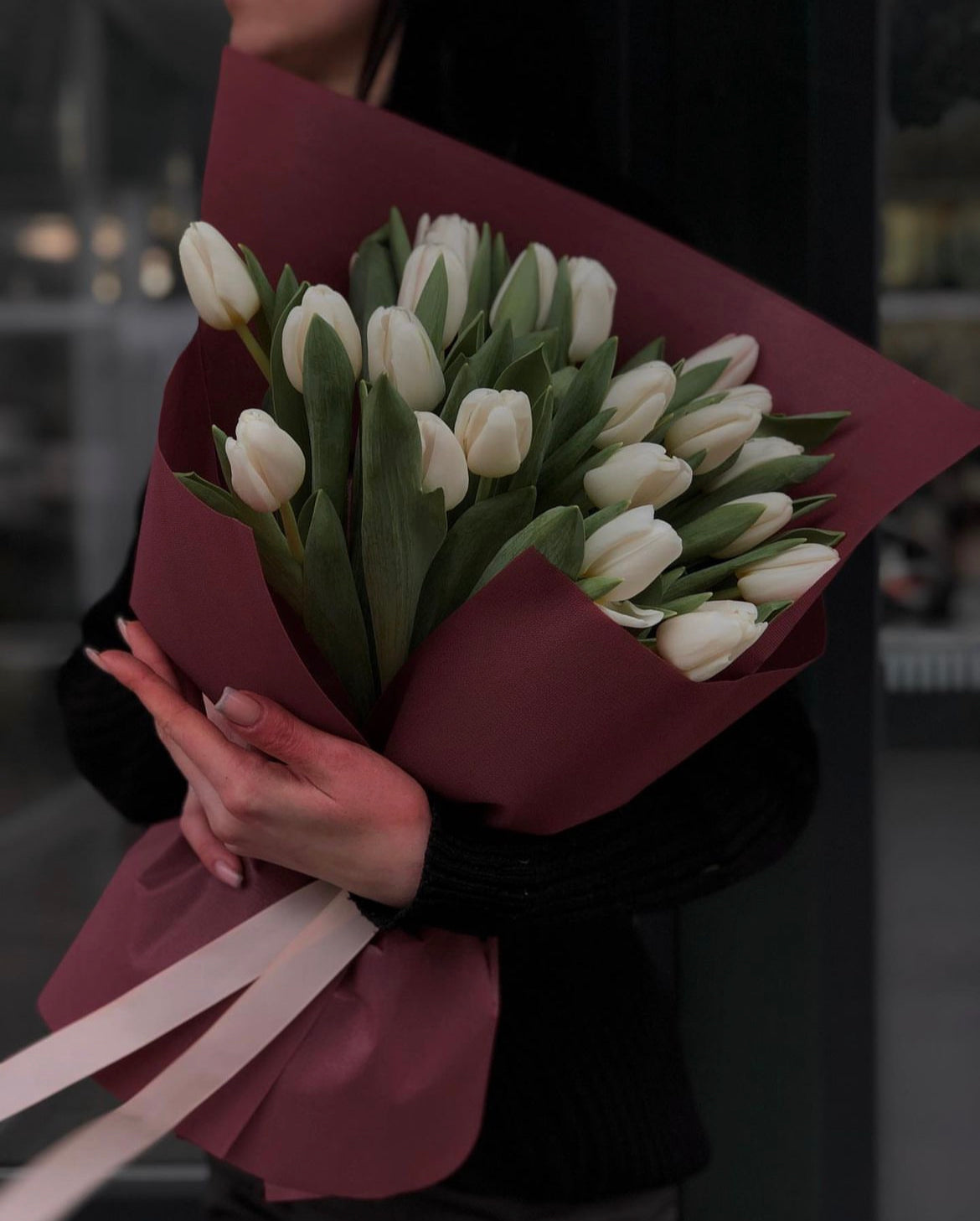 A beautiful bouquet of fresh tulips in mixed seasonal colors, wrapped in elegant paper, ready for same-day flower delivery.